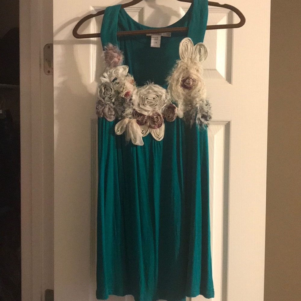 Teal tank with design on top.